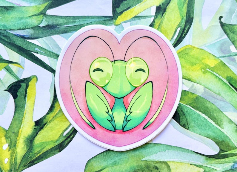 May include: A green praying mantis with large, round eyes and a happy expression is depicted inside a pink heart. The image is drawn in a cartoon style with watercolor-like textures.