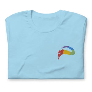 May include: A light blue t-shirt with a rainbow worm on the front. The worm has red eyes and is smiling.