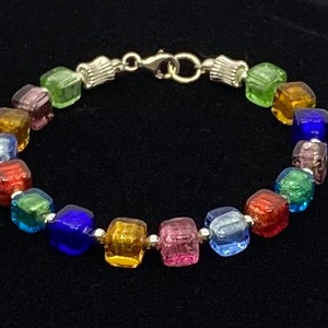 Multi-colored Venetian, cube-shaped glass, accented with sterling silver is featured in handmade bracelet