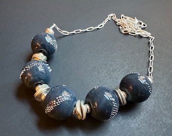 Artisan made lampwork glass beads in denim blue with fine silver detail are paired with sterling silver in handmade necklace