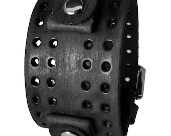 May include: Black leather bracelet with a silver buckle and a perforated design. The bracelet has two silver snaps.