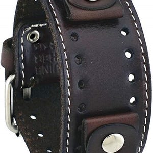 May include: A dark brown leather watch band with white stitching and silver metal accents. The band has a buckle closure and a loop for securing the strap.