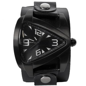 Puede incluir: Un reloj de pulsera negro con una esfera triangular y una correa de cuero negro. La esfera del reloj tiene números y manecillas blancas. La correa tiene detalles en metal plateado.