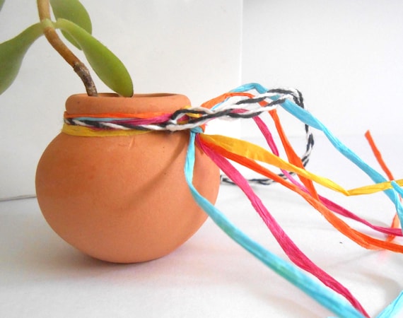 A genuine miniature terracotta pueblo pot handcrafted in a traditional Southwest style — more tiny art object than generic dish.