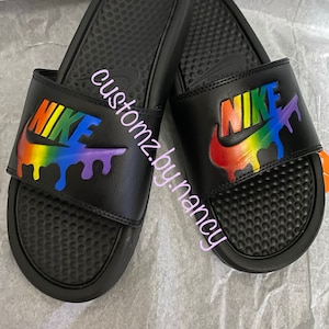 maroon nike slides with gold swoosh