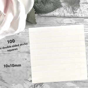 May include: A sheet of 100 white, mini double-sided sticky squares, each measuring 10x10mm.