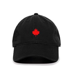 May include: A black baseball cap with a red Canadian maple leaf embroidered on the front.