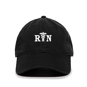 May include: Black cotton baseball cap with a white embroidered medical symbol and the letters "RN".