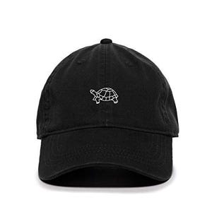 May include: A black cotton baseball cap with a white embroidered outline of a turtle.