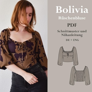 May include: A brown and purple floral print blouse with a ruffled neckline and long sleeves. The pattern includes large floral designs and a tie at the neckline. The text "Bolivia Rüschenbluse PDF Schnittmuster und Nähanleitung DE + ENG" is visible on the right side of the image.
