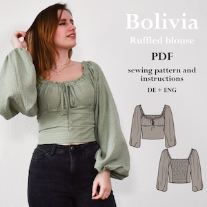 Pode incluir: Um padrão de costura para uma blusa verde com babados com instruções em alemão e inglês. O padrão inclui duas ilustrações da blusa.