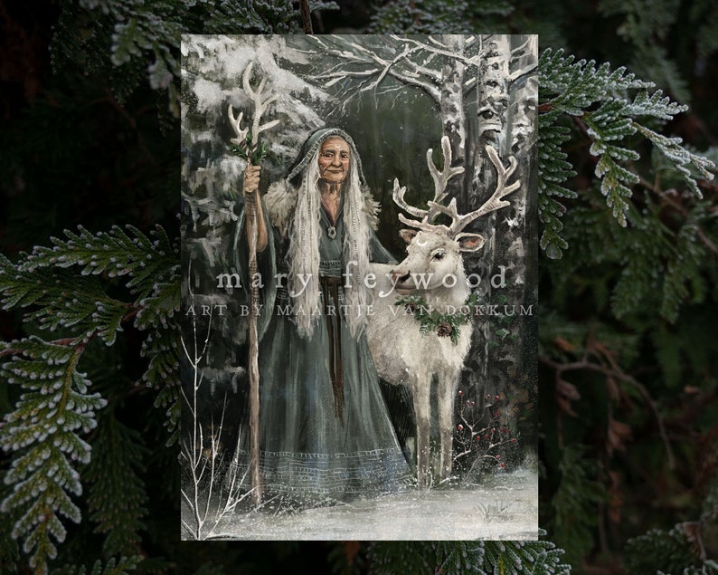 May include: A rectangular art print featuring an elderly person with long white hair wearing a dark hooded cloak, holding a wooden staff, and standing beside a white deer in a snowy forest. The text reads mary feywood. ART BY MAARTJE VAN DOKKUM.