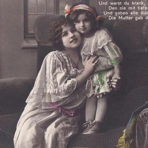 German postcard circa 1910: Mother and daughter snuggled together