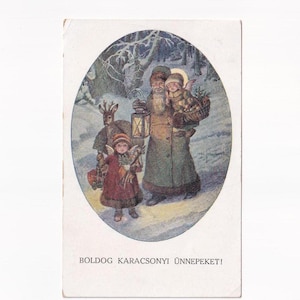 Père Noël en manteau vert avec des anges d'hiver et des cerfs, carte postale autrichienne ancienne, envoyée en 1921