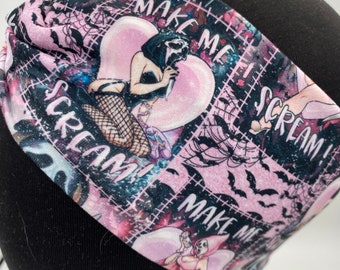 May include: Pink and black headband with a repeating pattern of bats, spiderwebs, and the text "Make Me Scream".