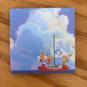 May include: Square sticker featuring a red boat with three cartoon characters sailing under a white sail with a blue and green design. The background shows a blue sky with fluffy white clouds.