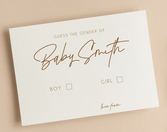 以下が含まれることがあります： GUESS THE GENDER OF Baby Smithと茶色の文字で書かれた白い長方形のカード。BOYとGIRLのチェックボックスと、love fromと書かれた記入欄があります。カードの右側には乾燥した植物の茎が添えられています。