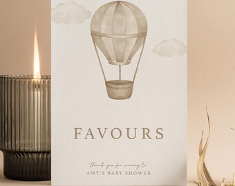 May include: A rectangular white card featuring a watercolor illustration of a beige hot air balloon and clouds. The text reads FAVOURS, thank you for coming to AMY'S BABY SHOWER, and FULL & LOVE at the bottom in a beige serif font.