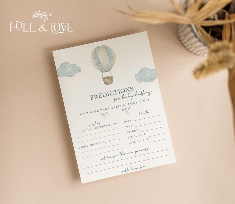 May include: A white baby shower prediction card featuring a watercolor illustration of a hot air balloon and blue clouds. The text reads PREDICTIONS for baby halling, WHO WILL BABY HALLING LOOK LIKE, DAD, MUM, wishes, and advice for the new parents.