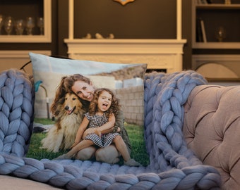 May include: A throw pillow with a photo of a woman and a young girl smiling with a dog sitting in front of them. The photo is taken outdoors in a grassy area.