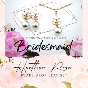 May include: Gold bridesmaid jewellery set with pearl drop earrings and necklace featuring a leaf design with clear crystals. The card says "Thank you for being my Bridesmaid" and "Heather Rose Pearl Drop Leaf Set Gold".