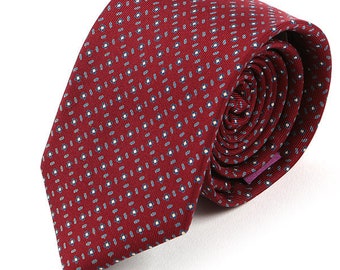 May include: A red patterned tie with a white and blue design. The tie is made of silk and has a classic shape.