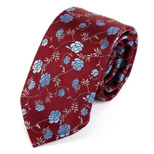 May include: A burgundy tie featuring a repeating pattern of light blue floral designs and delicate vines. The tie is made of a smooth fabric, suitable for formal or semi-formal occasions.