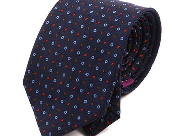 May include: A navy blue tie with a repeating pattern of small red, blue, and brown circles.