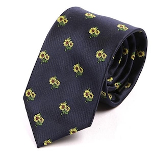 May include: A navy blue tie with a repeating pattern of yellow sunflowers.