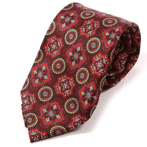 May include: A brown silk tie with a red and gold geometric pattern.