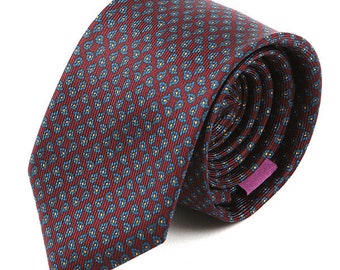 May include: Rolled burgundy tie with a repeating pattern of small blue and yellow floral designs. The tie is made of a textured fabric and has a purple label on the back.