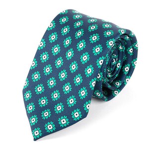 May include: A dark blue necktie with a repeating pattern of white and green floral designs.