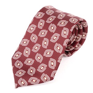 May include: A burgundy silk tie with a white geometric pattern. The pattern is made up of small, repeating shapes that resemble eyes.