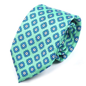 May include: A green silk tie with a blue and white floral pattern.