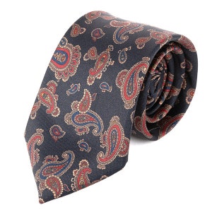 May include: A dark blue paisley patterned tie with red, blue and beige accents.