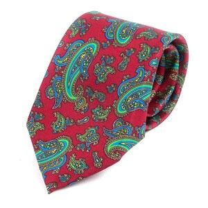 May include: A red tie with a paisley pattern in blue and green.