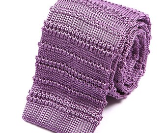 May include: A purple knitted tie with a textured pattern. The tie is rolled up and ready to be worn.