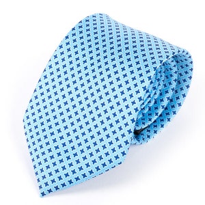 May include: A light blue tie with a small, repeating pattern of blue crosses.