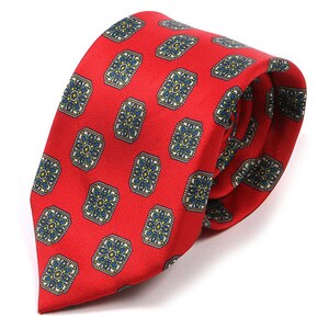 May include: A red silk tie with a repeating pattern of blue and white floral designs.