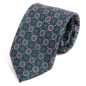 May include: A green tie featuring a repeating geometric pattern of red, white, and blue circles and squares. The tie is made of a smooth fabric, suitable for formal or business wear.