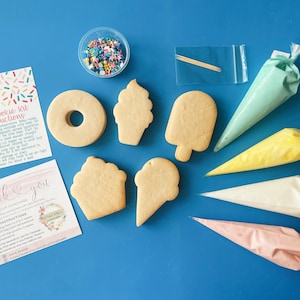 May include: A DIY cookie kit with a variety of cookie shapes, including a donut, cupcake, ice cream cone, and popsicle. The kit also includes four piping bags filled with different colored frosting, sprinkles, and a thank you card with instructions.