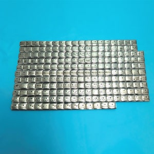 May include: A collection of silver-toned metal charms with various engraved words and phrases. The charms are arranged in rows on a blue background. Some of the words include "I Love", "Irish", "Italian", "Polish", "Shoes", "Sushi", "Tap", "Teach", and "USA".
