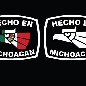 May include: Two white rectangular labels with rounded corners on a black background. The labels have the text "HECHO EN" and "MICHOACAN" in white. The left label features a stylized eagle with the Mexican flag colors. The right label features a white stylized eagle.