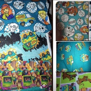 May include: Fabric featuring cartoon characters in circles, the Mystery Machine van, and other graphics. The fabric has a teal background with white polka dots and various character illustrations. The fabric is suitable for crafting and sewing projects.