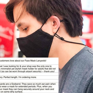 May include: A person wearing a black face mask with a black lanyard. The lanyard is attached to the mask and goes around the person's neck. The text on the image reads: "What our customers love about our Face Mask Lanyards! Exactly what I was looking for & your shop was the only one to have it -- a minimalist yet stylish mask holder for adults that did not have metal (so can be worn through airport security) -- thank you! Fast delivery. Perfect length. I'm ordering more. These lanyards are a Godsend. They save so much ear pain when you have to wear a mask for extended periods. Plus, when you remove your mask they can hang securely around your neck and not end up on some dirty surface."