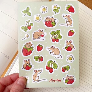May include: A sheet of stickers featuring cute cartoon mice eating strawberries. The stickers are on a light green background with white outlines. The stickers are perfect for adding a touch of whimsy to your planner, journal, or laptop.