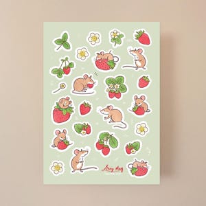 May include: A sheet of stickers featuring illustrations of mice eating strawberries. The stickers are on a light green background and have a white border. The text "Lucy May" is in the bottom center of the sheet.