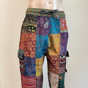 May include: Patchwork pants with a variety of colorful patterns and designs. The pants have a drawstring waist and two side pockets.
