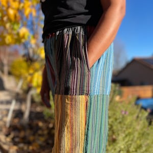 May include: Multicolored striped pants with a patchwork design. The pants are made of a soft, comfortable fabric and have a relaxed fit.