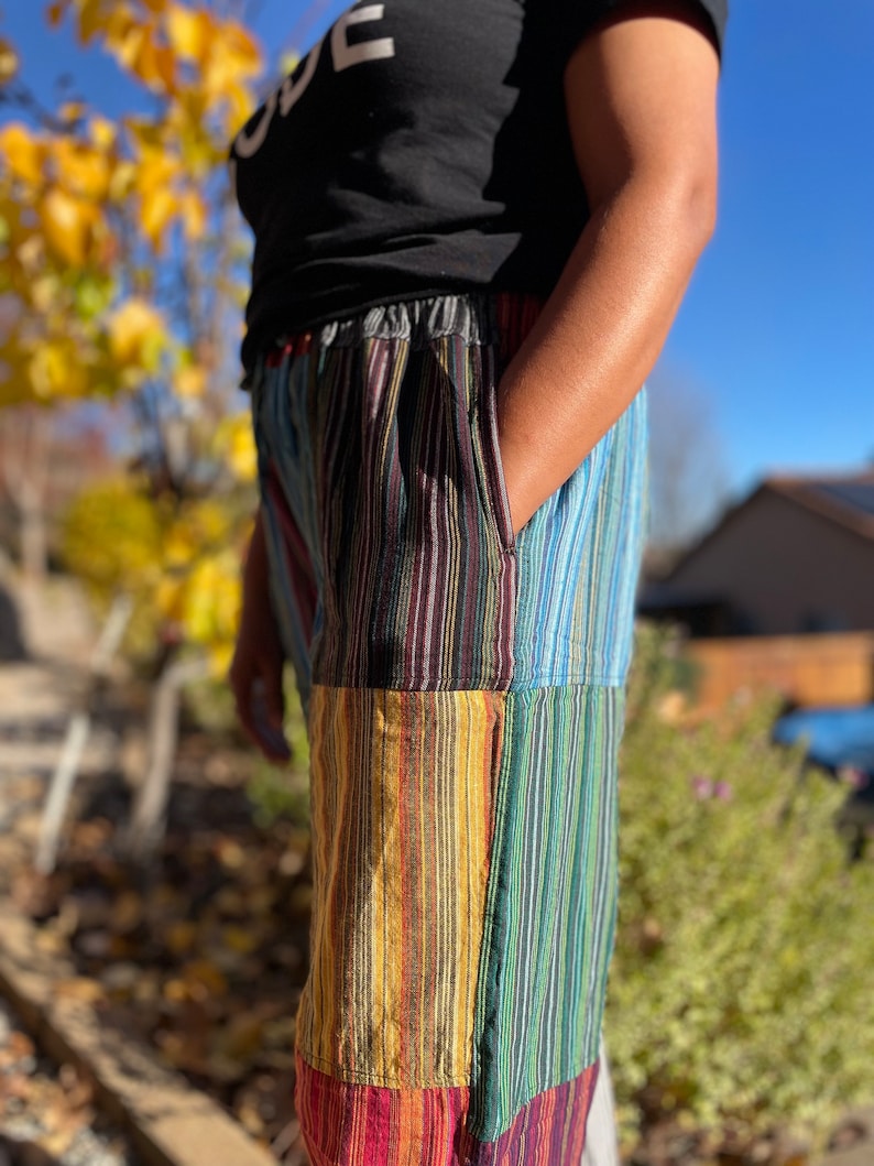 May include: Multicolored striped pants with a patchwork design. The pants are made of a soft, comfortable fabric and have a relaxed fit.
